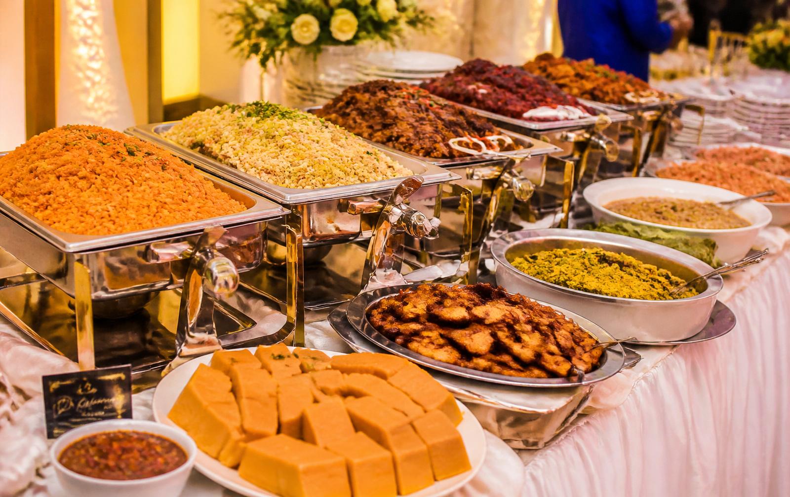 Nigerian buffet catering spread with chafing dishes